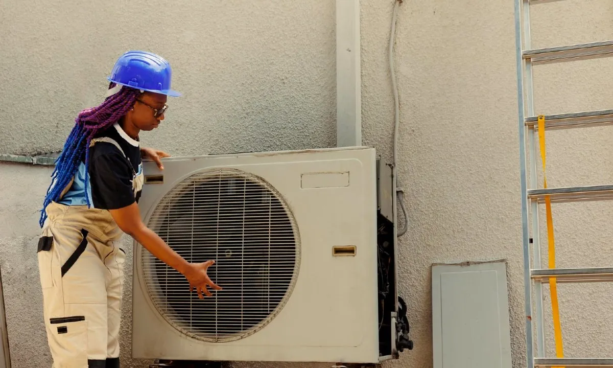 Female technician servicing an air conditioning unit. (Source: DC Studio on Freepik)