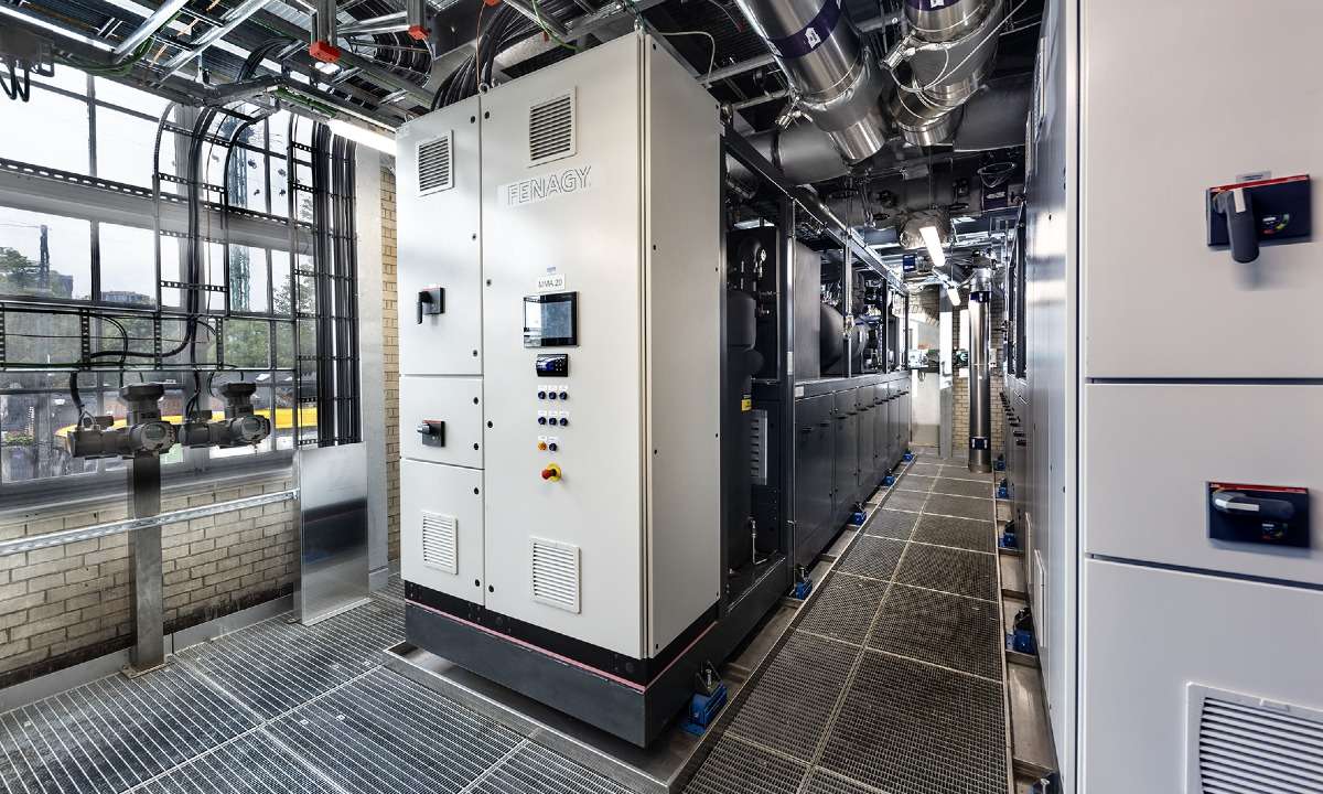 Two of the three Fenagy CO2 heat pumps installed at the Tietgensgade facility with compressor panels and vibration feet. Photo credit: Fenagy