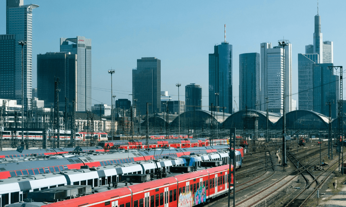 The image of a train in a station showcases the ability to decarbonize railway maintenance hubs with R290 heat pumps.