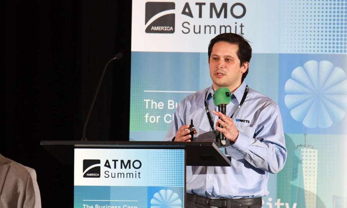 An image of Andrew Macaluso, Senior Product Manager of System Solutions at Lync by Watts, presenting at ATMO America. He outlined benefits of CO2 heat pumps for domestic hot water production.