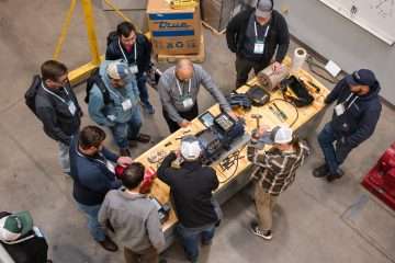 Technicians at an NASRC Training Summit examining a compressor. Photo credit: The NASRC