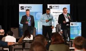 An image of Jeremy McConkey, Training Director at Local 455, Alessandro Silva, Senior Application Engineer at Bitzer, and Sean Jarvie, CTO of Flow Environmental Systems, presenting at ATMO America. They discussed the installation of a CO2 heat pump for HVAC and domestic hot water in Local 455 training facility in St. Paul, MN.